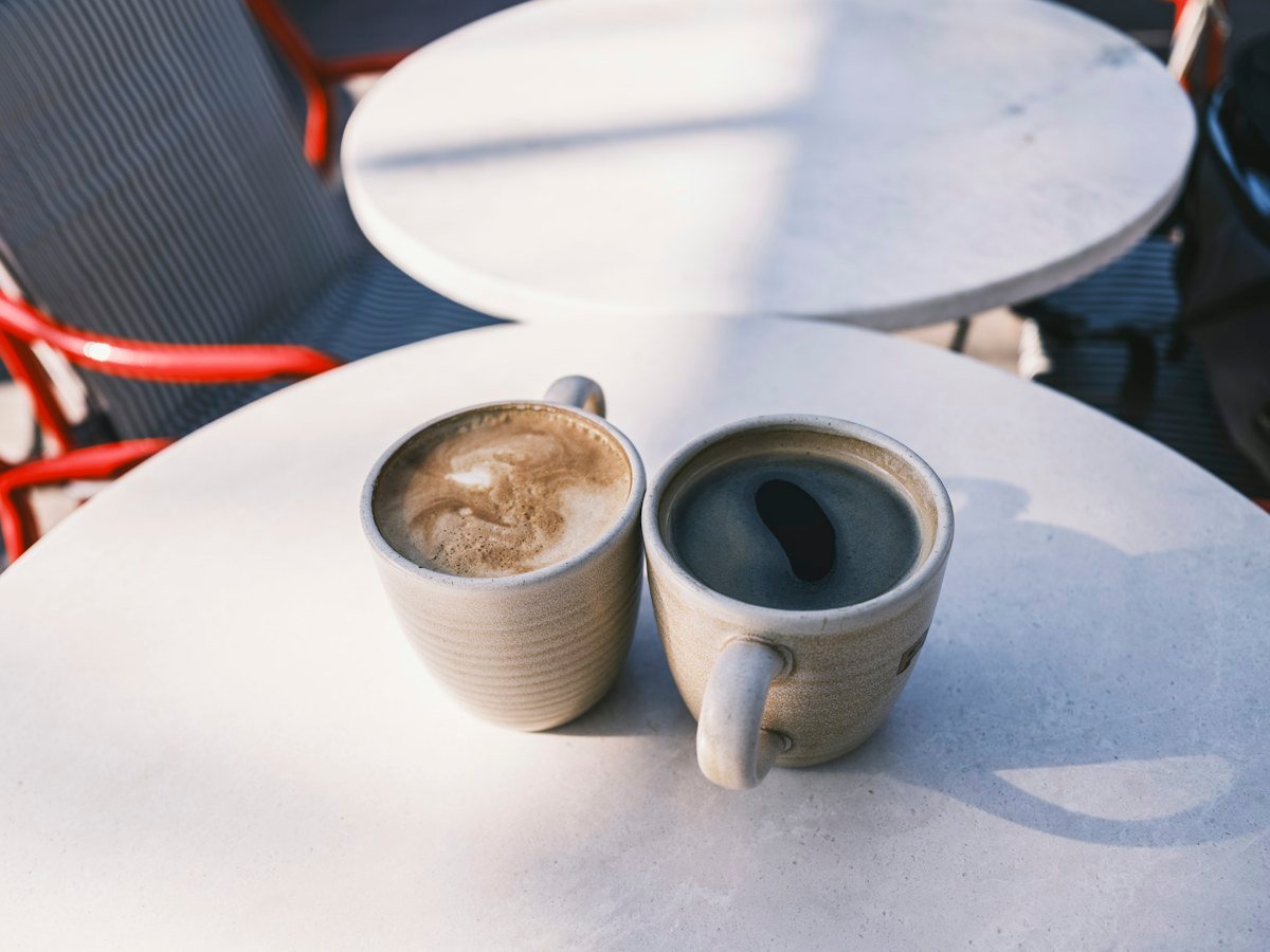 Two cups of coffee on a café table